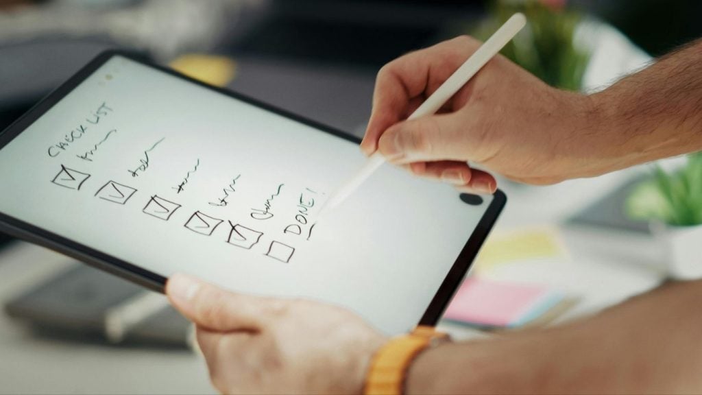 Seasonal home maintenance checklist. Person holding a tablet with a digital checklist, ticking off tasks with a stylus; all items are ticked and marked as "DONE!". - The Handyman Services York Region & Simcoe Region